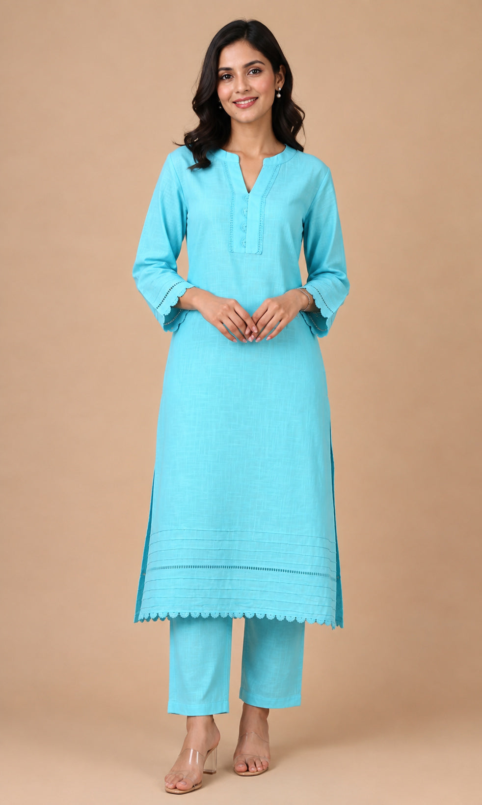 A woman modeling a light blue kurta and matching trouser set against a solid beige studio background.